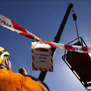Crane operation safety zone flagged with tags and tape